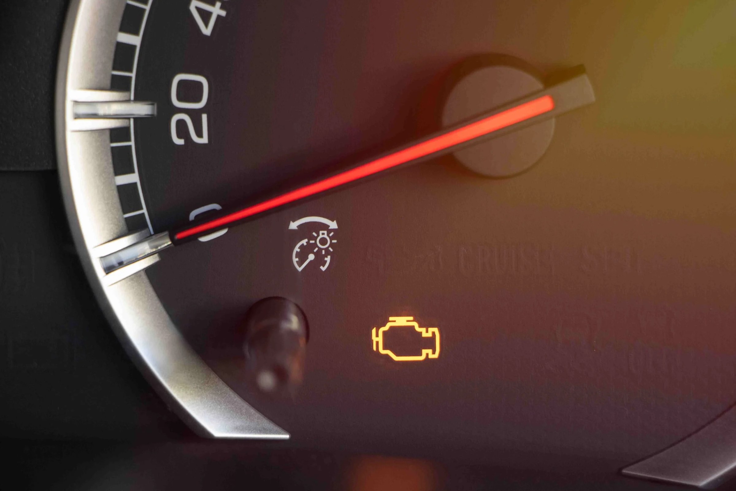 Voyant moteur orange allumé sur le tableau de bord d'une voiture